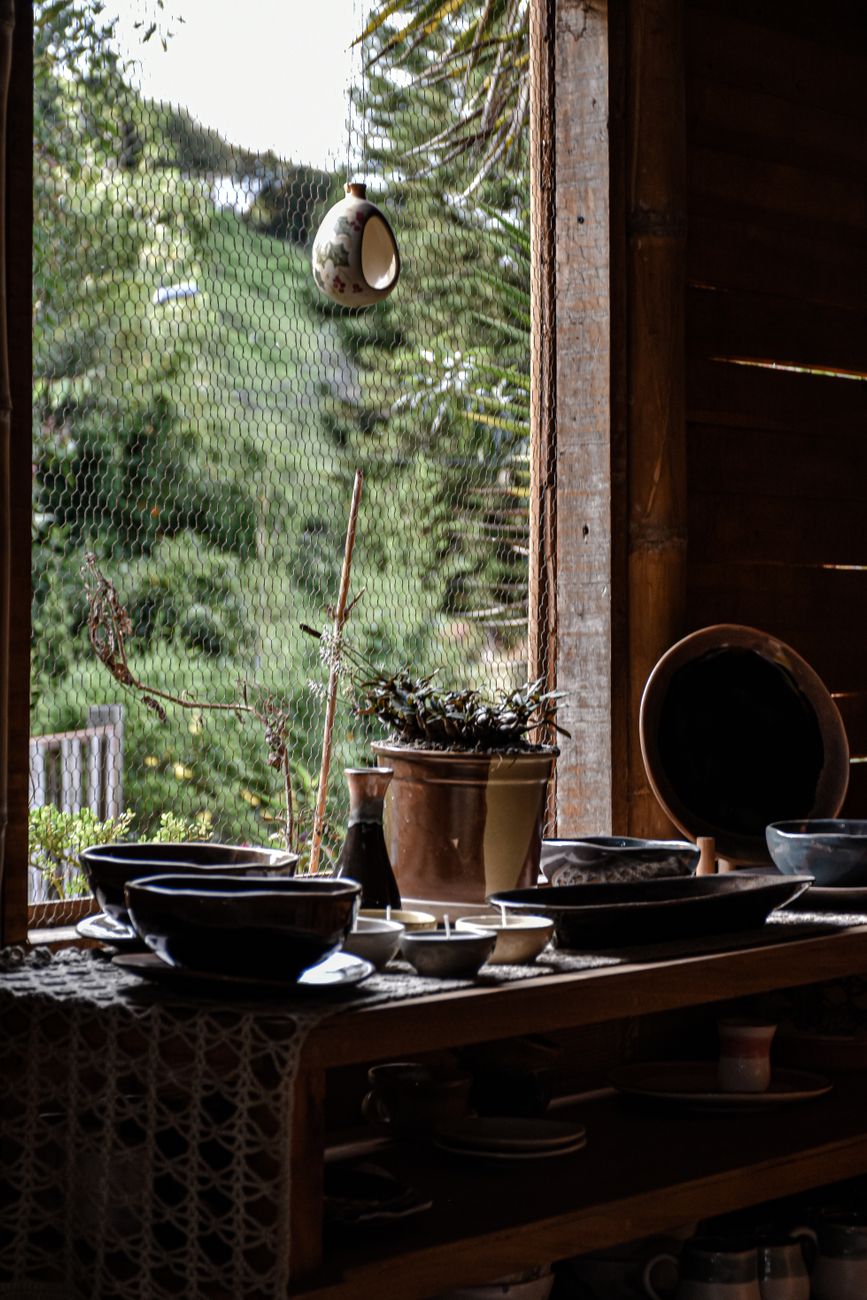 A beautiful arrangement of ceramics in a rustic workshop in El Carmen de Viboral, Colombia.