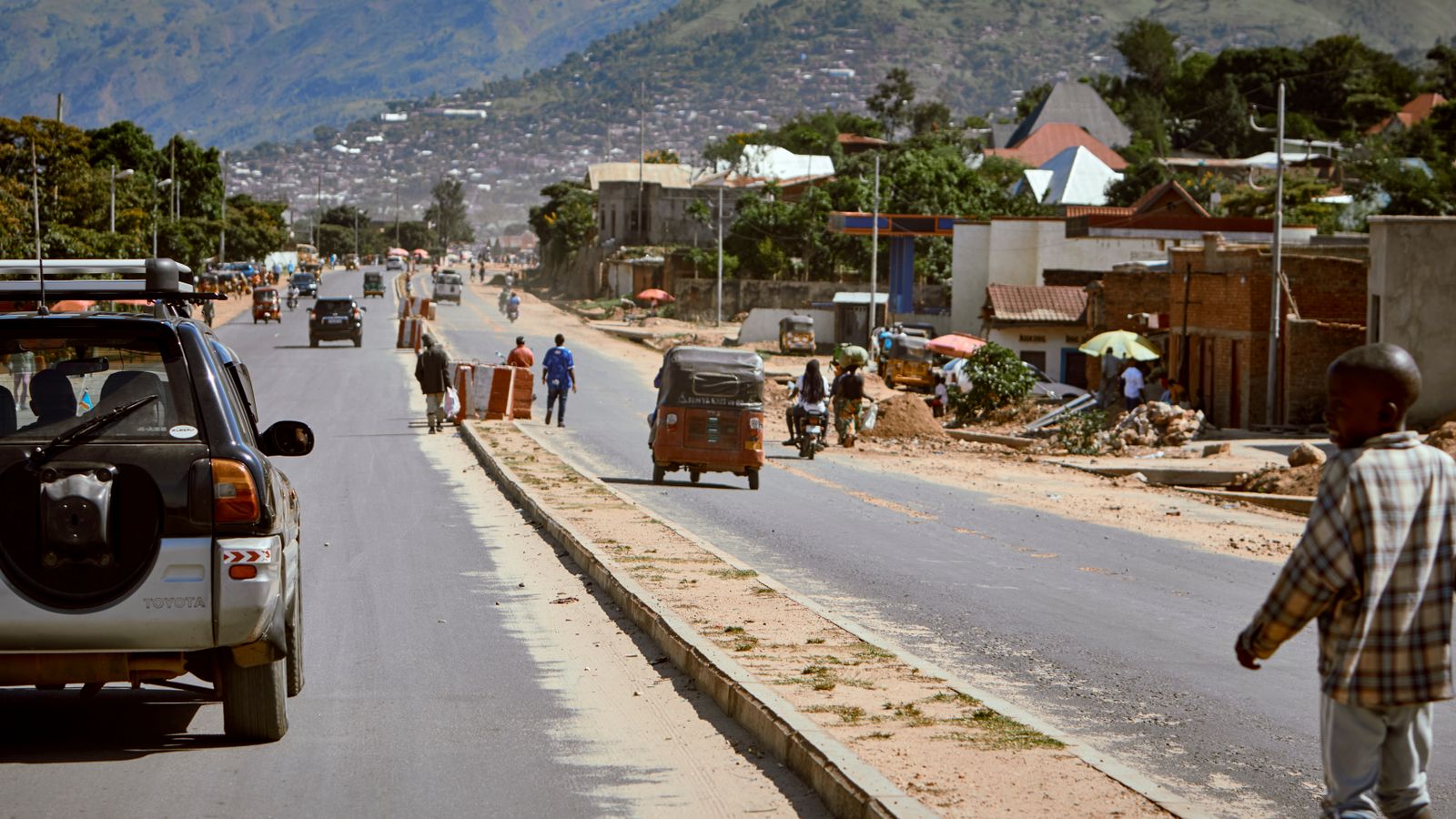 Bustling roadway in african town with mountains, Eritrea