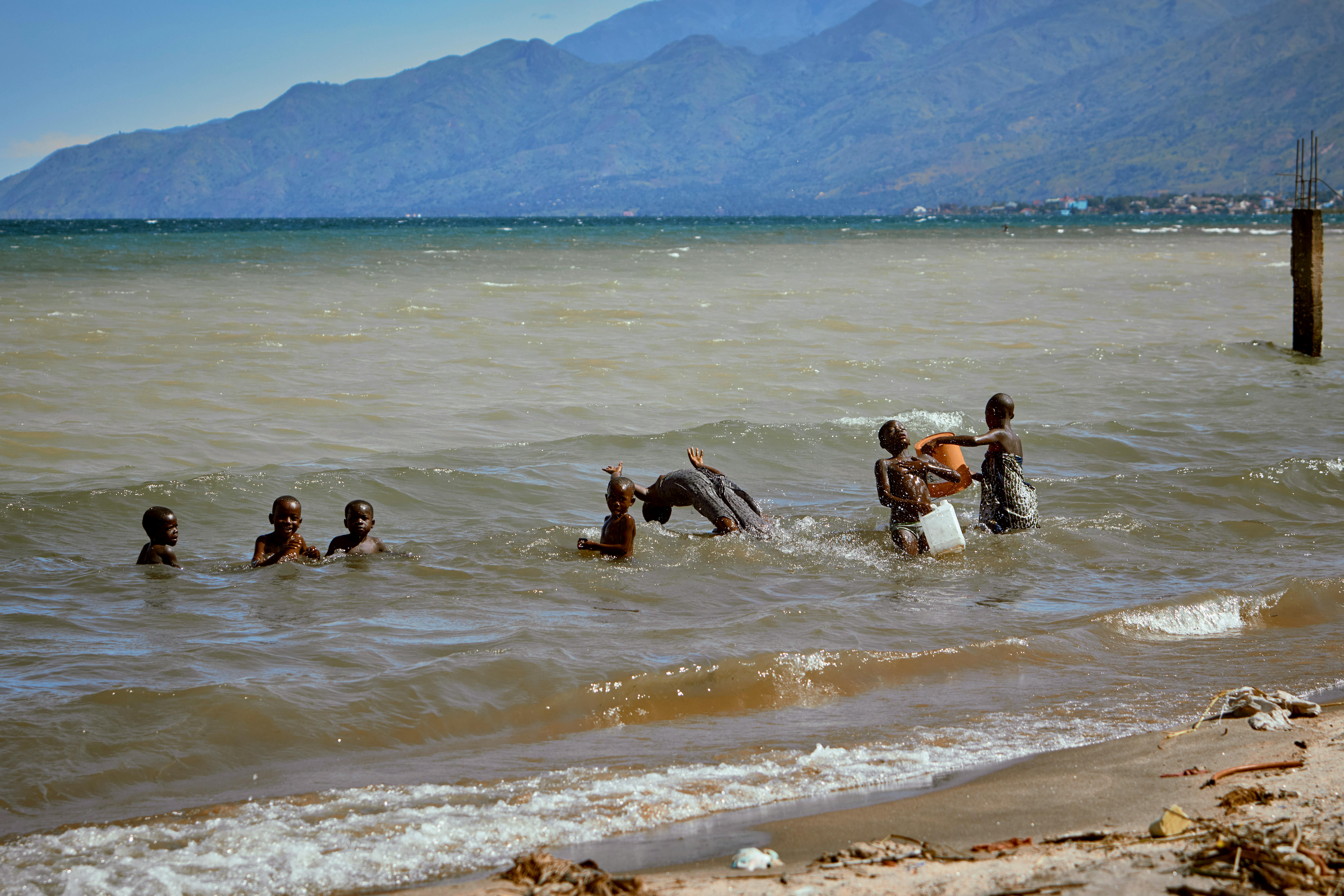 Quiet shoreline of Lake Tanganyika with distant hills