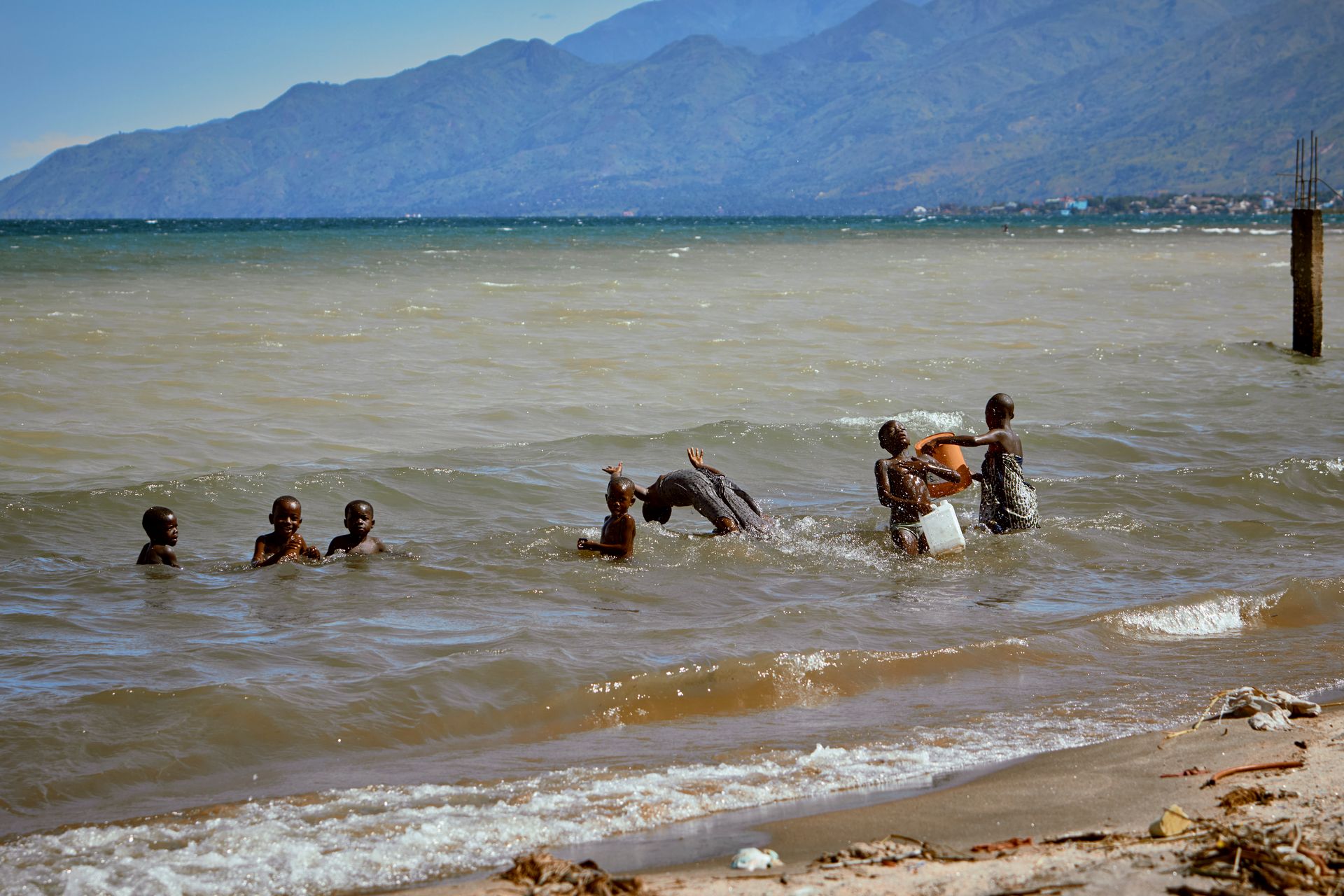 Quiet shoreline of Lake Tanganyika with distant hills