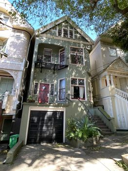 A classic Victorian-style house in San Francisco, showcasing bay windows and intricate details.