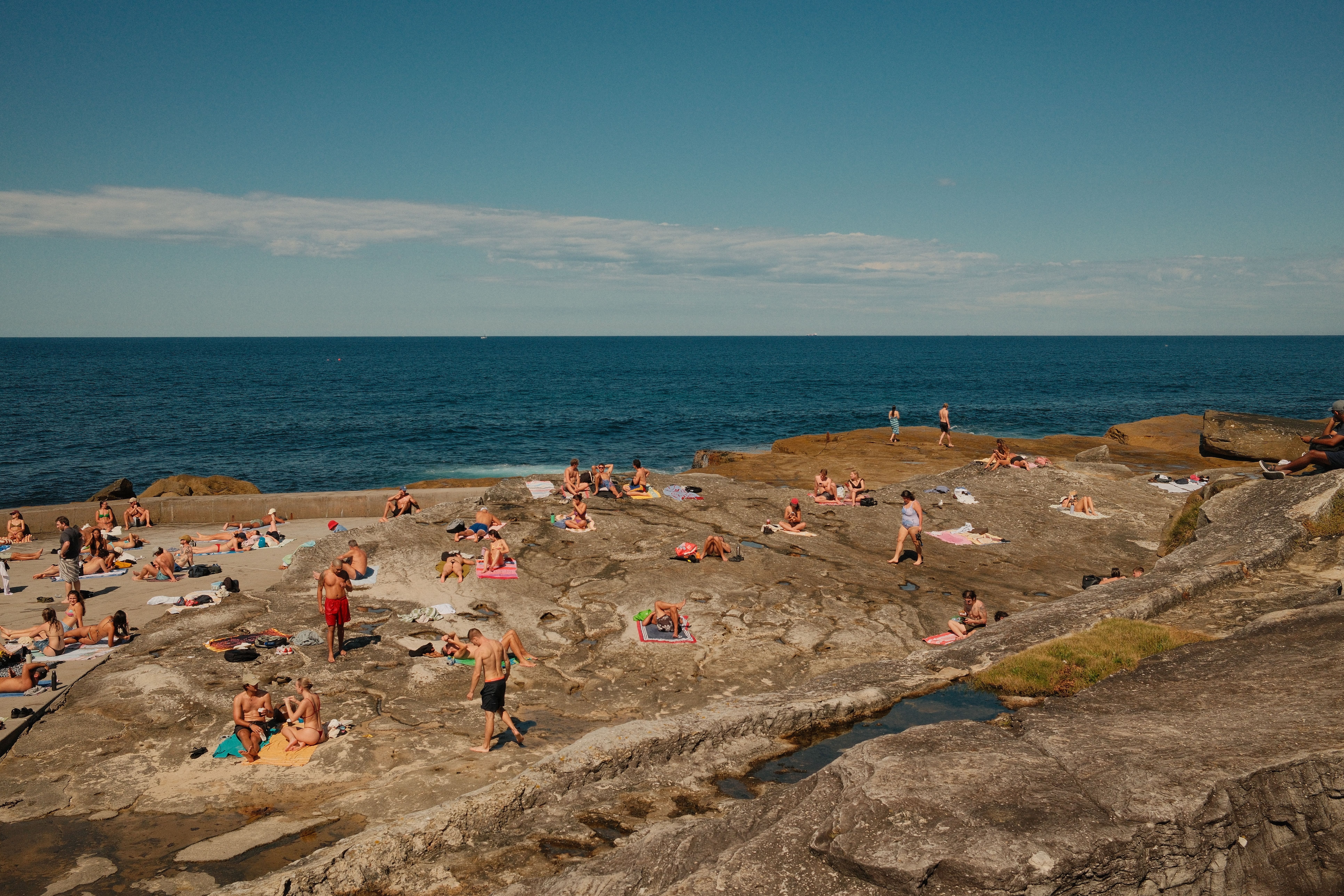 Bondi Beach coastal walk, sunshine, distant figures