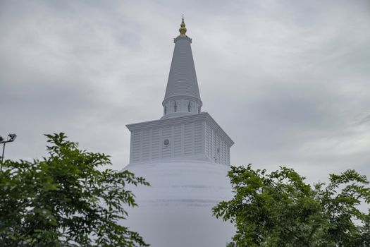 A stunning view of the white Ruwanwelisaya Stupa under cloudy skies in Anuradhapura, Sri Lanka.