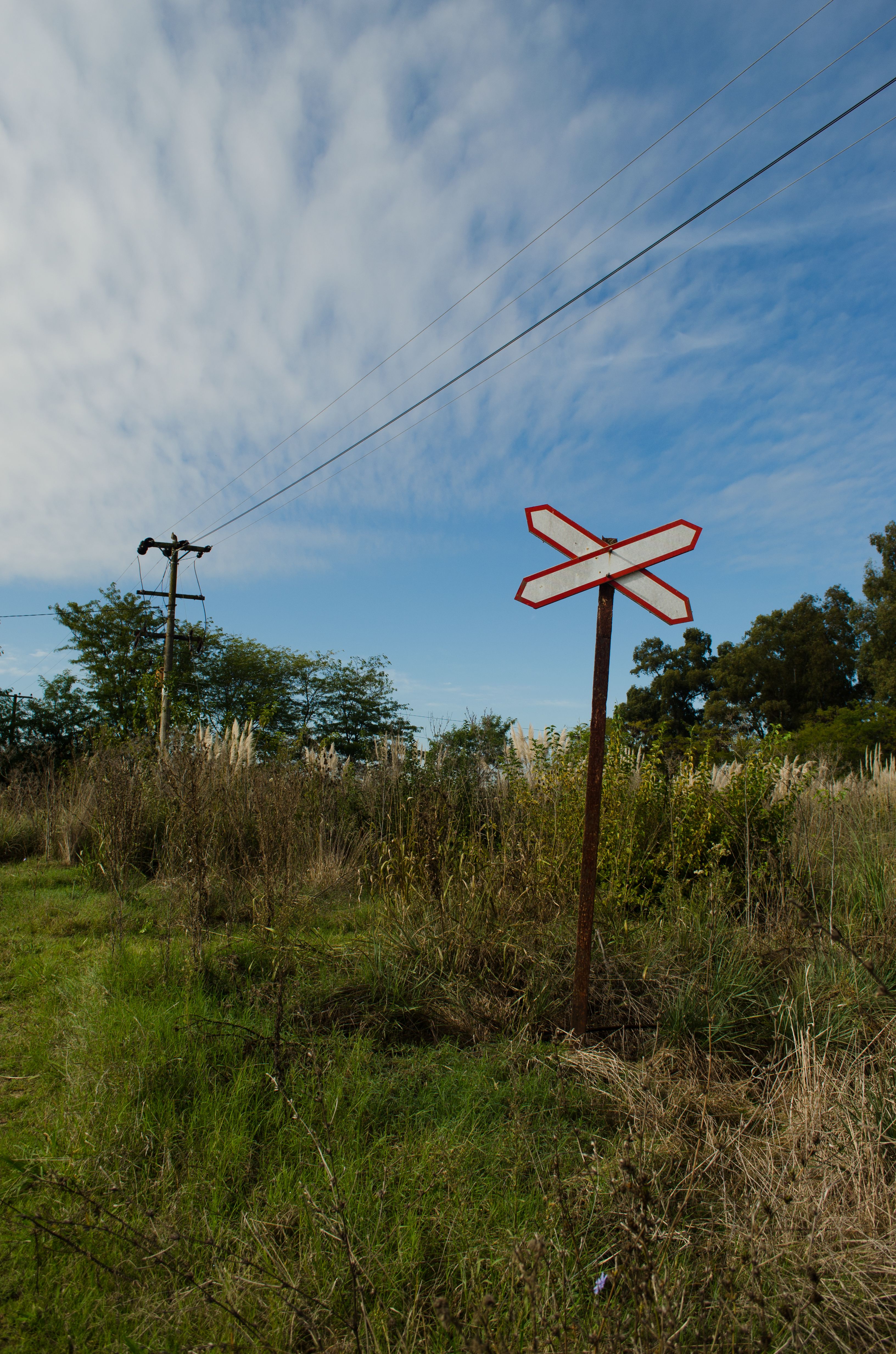 Rustic Train Track Sign in Rural Landscape · Free Stock Photo