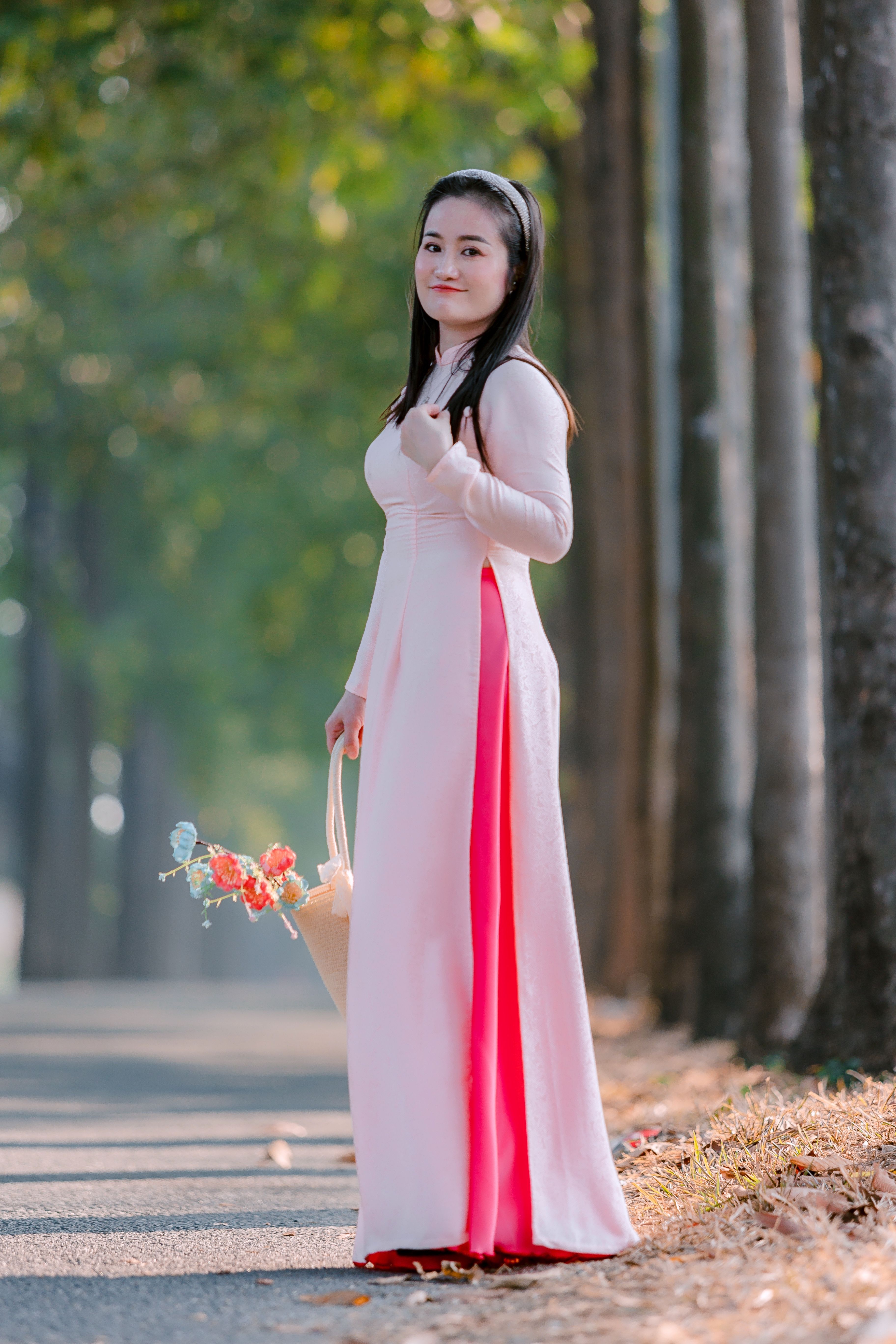 Elegant Woman in Traditional Pink Dress Outdoors · Free Stock Photo