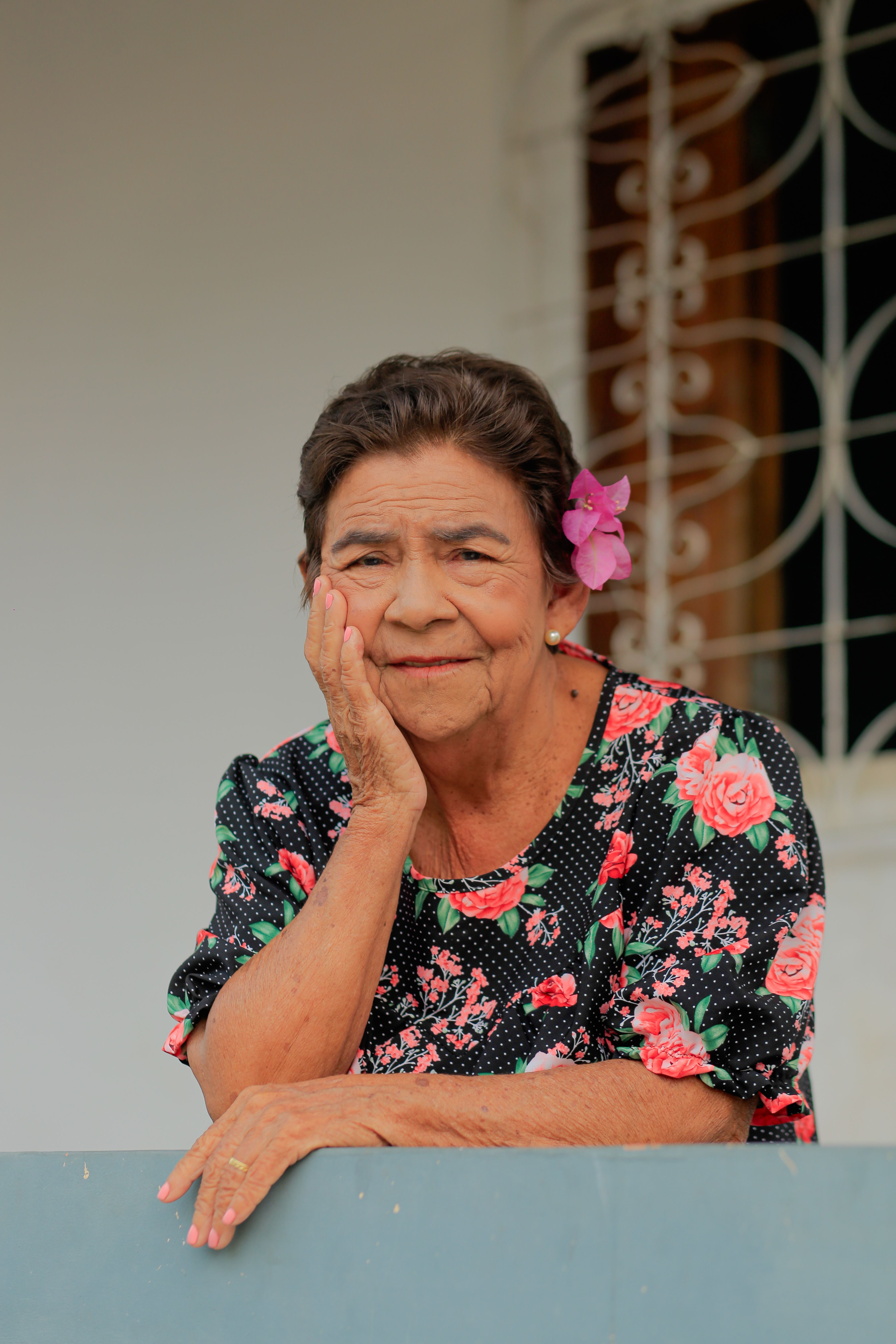 Elderly Woman in Floral Dress Standing in the Field  Free Stock Photo