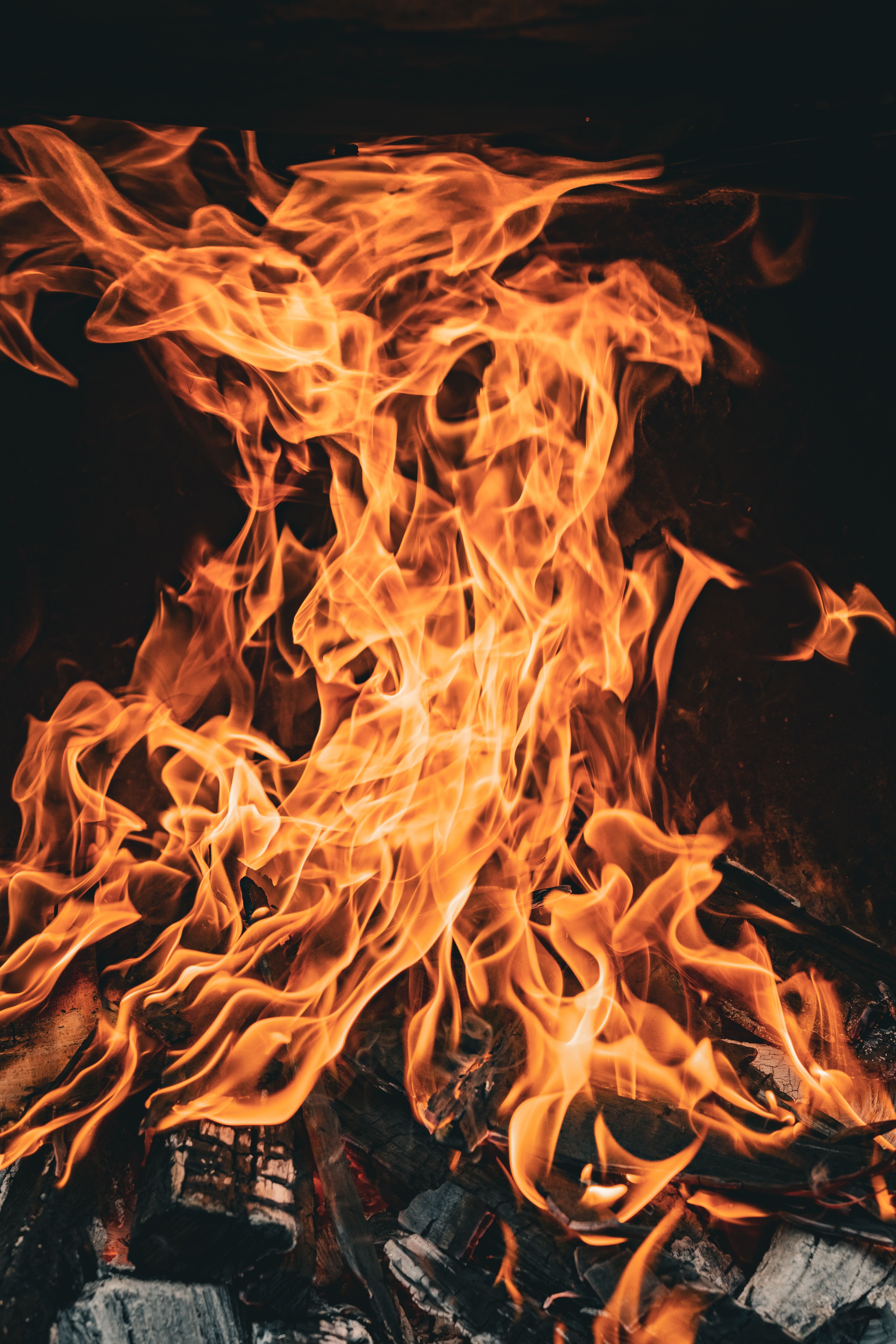 A dynamic close-up of vibrant flames and burning coals, evoking warmth and energy.
