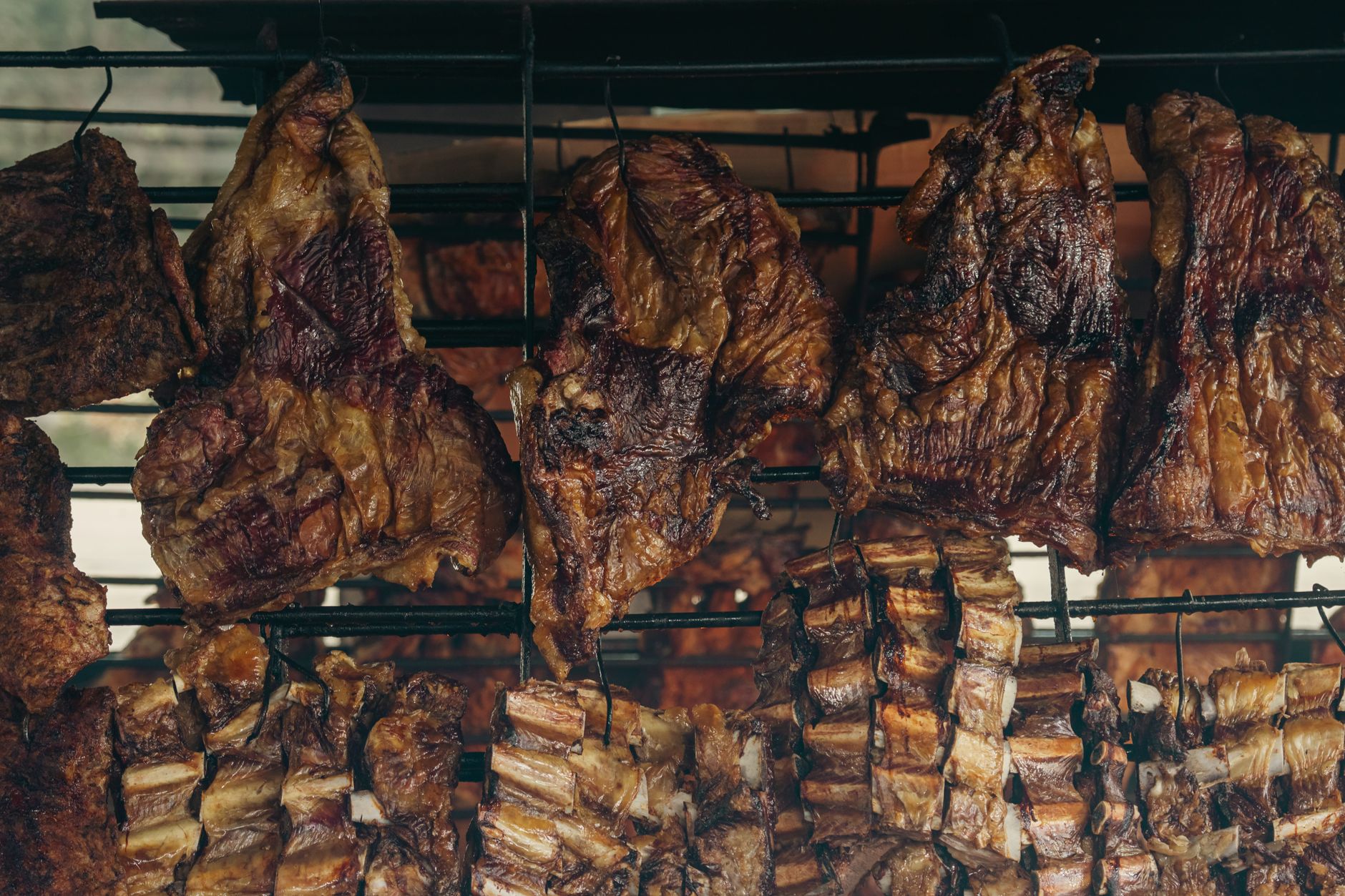 Close-up of meats roasting on a traditional Argentine parilla grill in Uribelarrea.