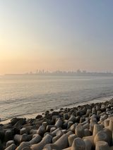 Tetrapods on the shore, Mumbai skyline at sunset