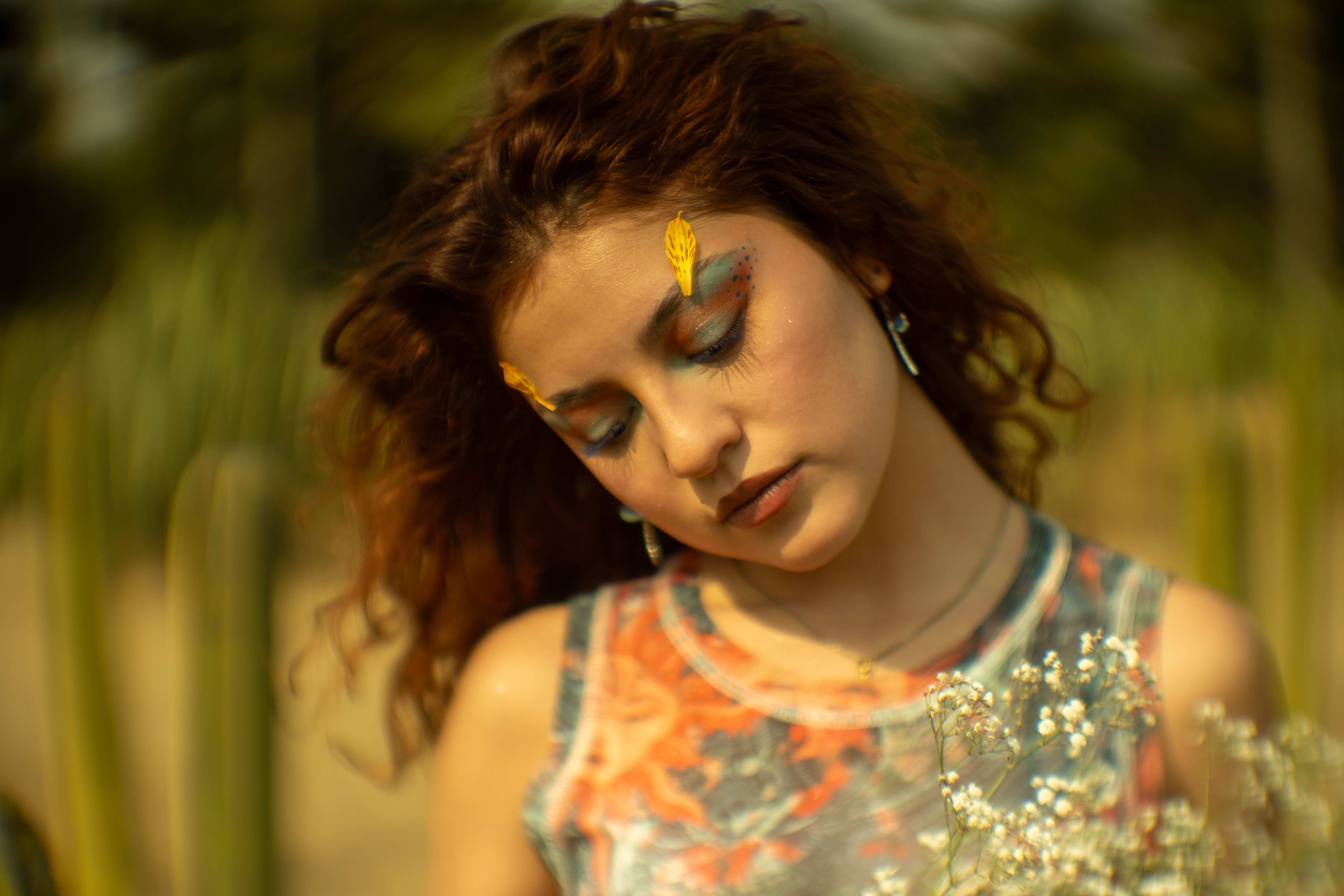 A dreamy portrait of a woman with unique flower makeup in Chapultepec Park, Mexico City.