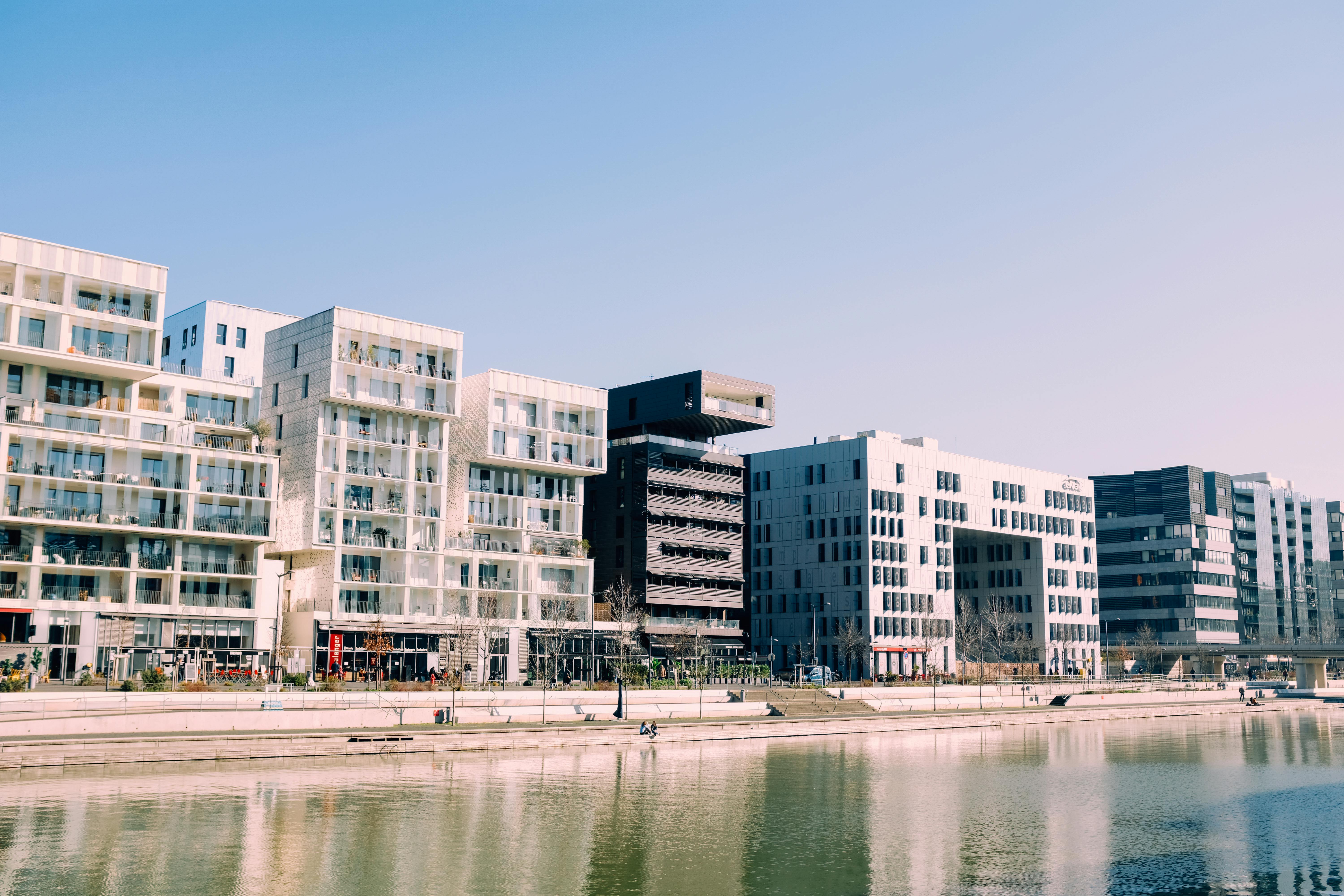 white concrete building near body of water