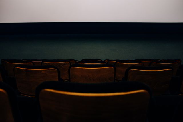Empty cinema seats in low light — photo by Adrien Olichon on Pexels