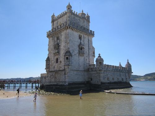 Free Capture of the iconic Belem Tower in Lisbon, Portugal, with tourists enjoying the summer sun. Stock Photo