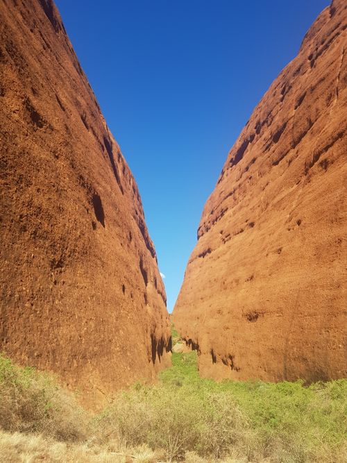 Free Experience the stunning red rock formations of Uluru, NT, Australia under a clear sky. Stock Photo
