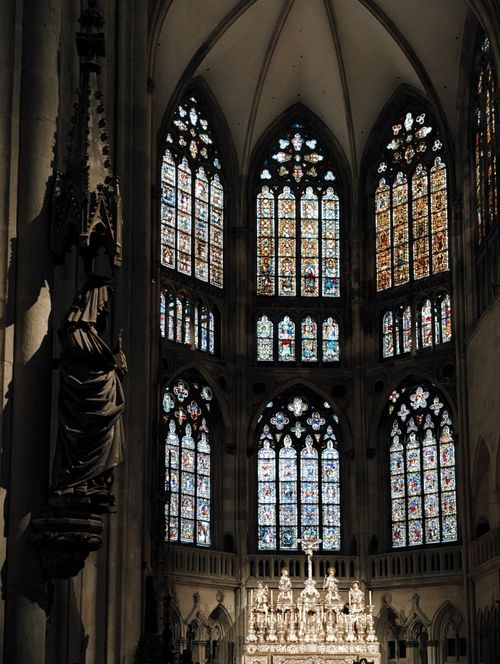 Free Stunning Gothic cathedral interior featuring intricate stained glass windows and architectural details. Stock Photo