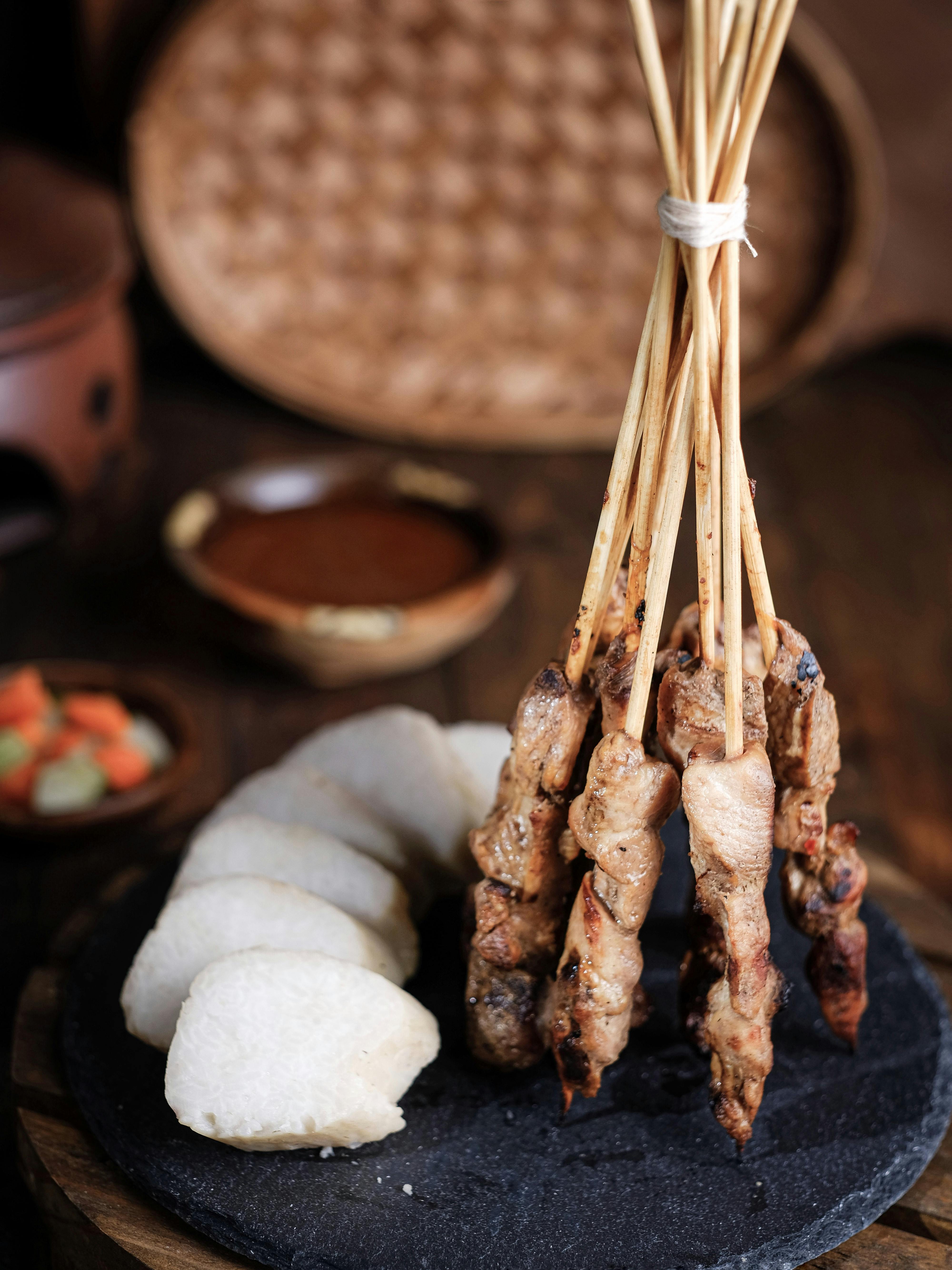 Grilled chicken and beef satay skewers served with peanut sauce, rice cakes, and sliced cucumber at Satay by the Bay Singapore