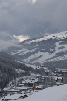 Snow-covered alpine village in Saalbach-Hinterglemm, Austria during winter.