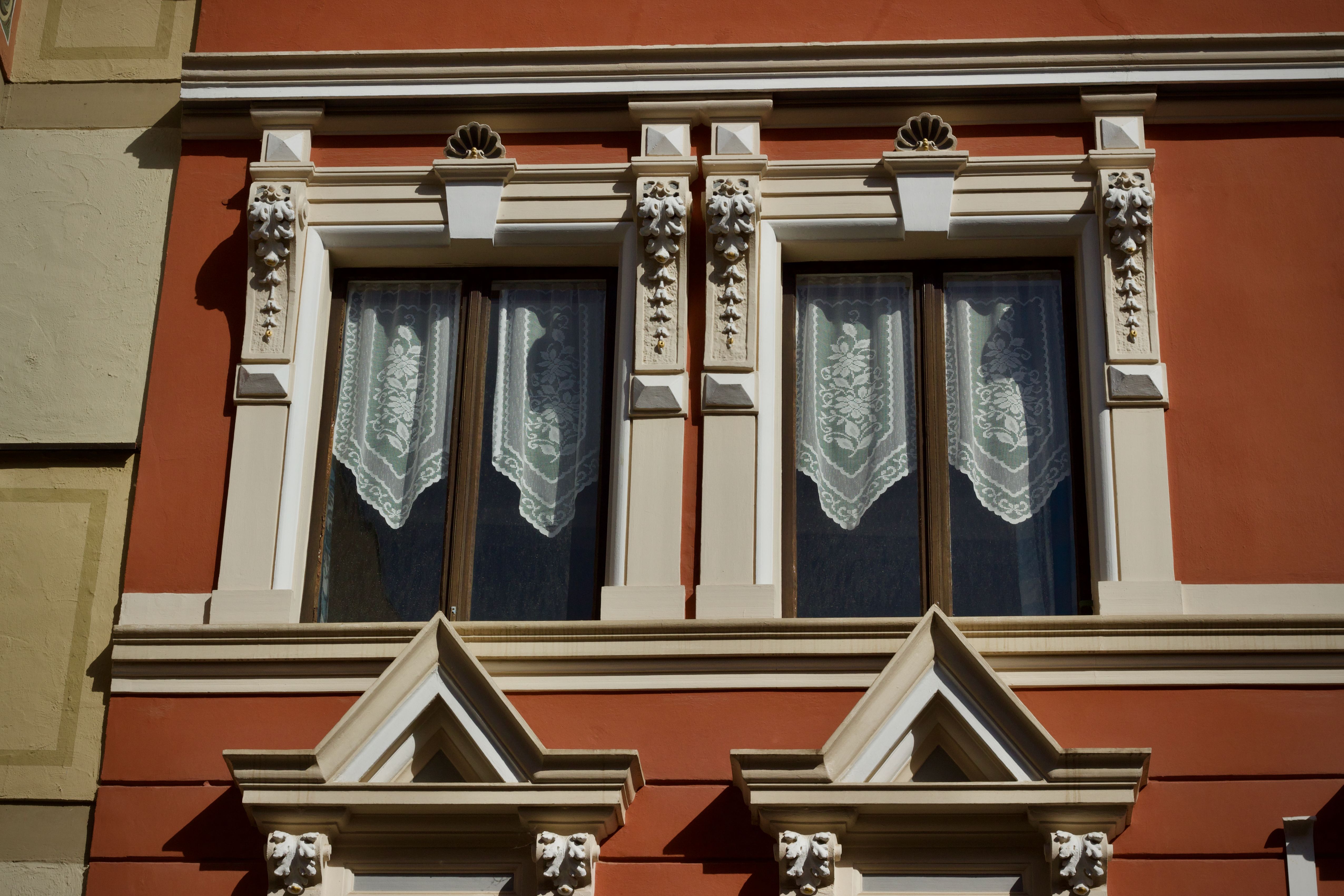 Ornate Architectural Window with Lace Curtains · Free Stock Photo