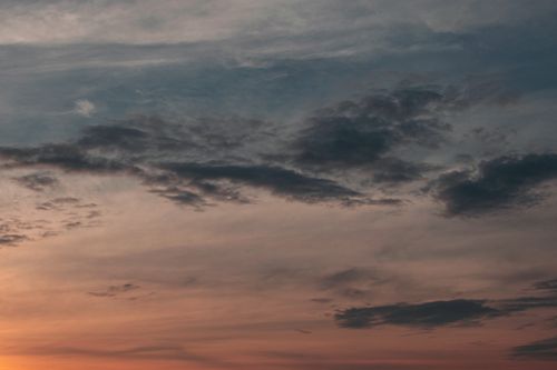 Free Capture of a colorful sunset sky with dramatic cloud formations, evoking a serene summer evening. Stock Photo