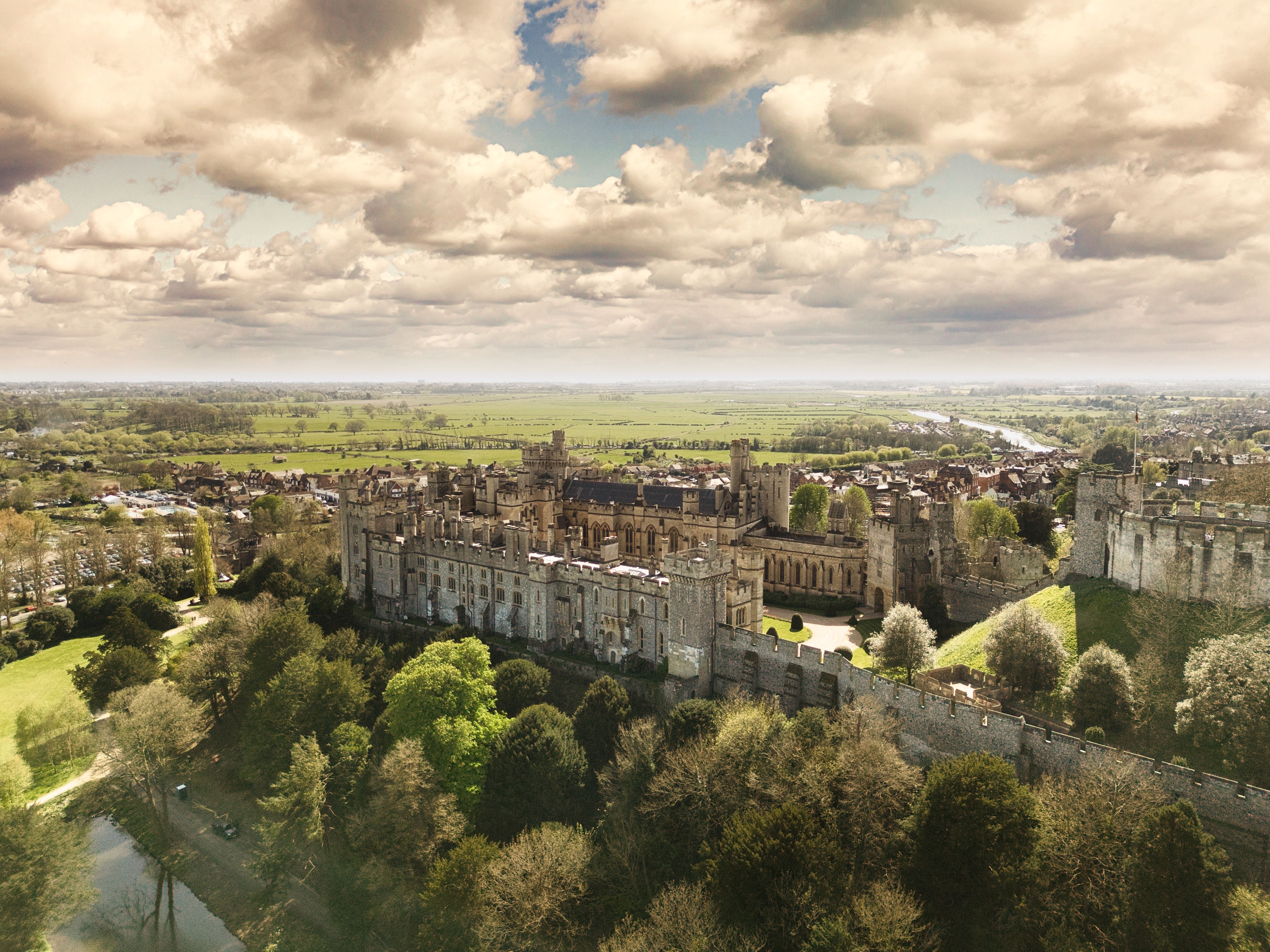 Incredible 25 Minute Royal Surrey Helicopter Tour Review: A Majestic Flight Over England's Finest Countryside Review 2026 - A breathtaking aerial shot of Arundel Castle surrounded by lush greenery and under a dramatic sky.