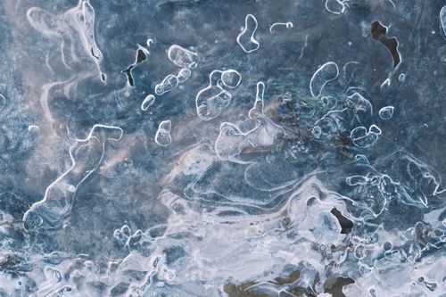 Free Close-up of abstract ice texture with frozen air bubbles, creating an artistic and cool pattern. Stock Photo
