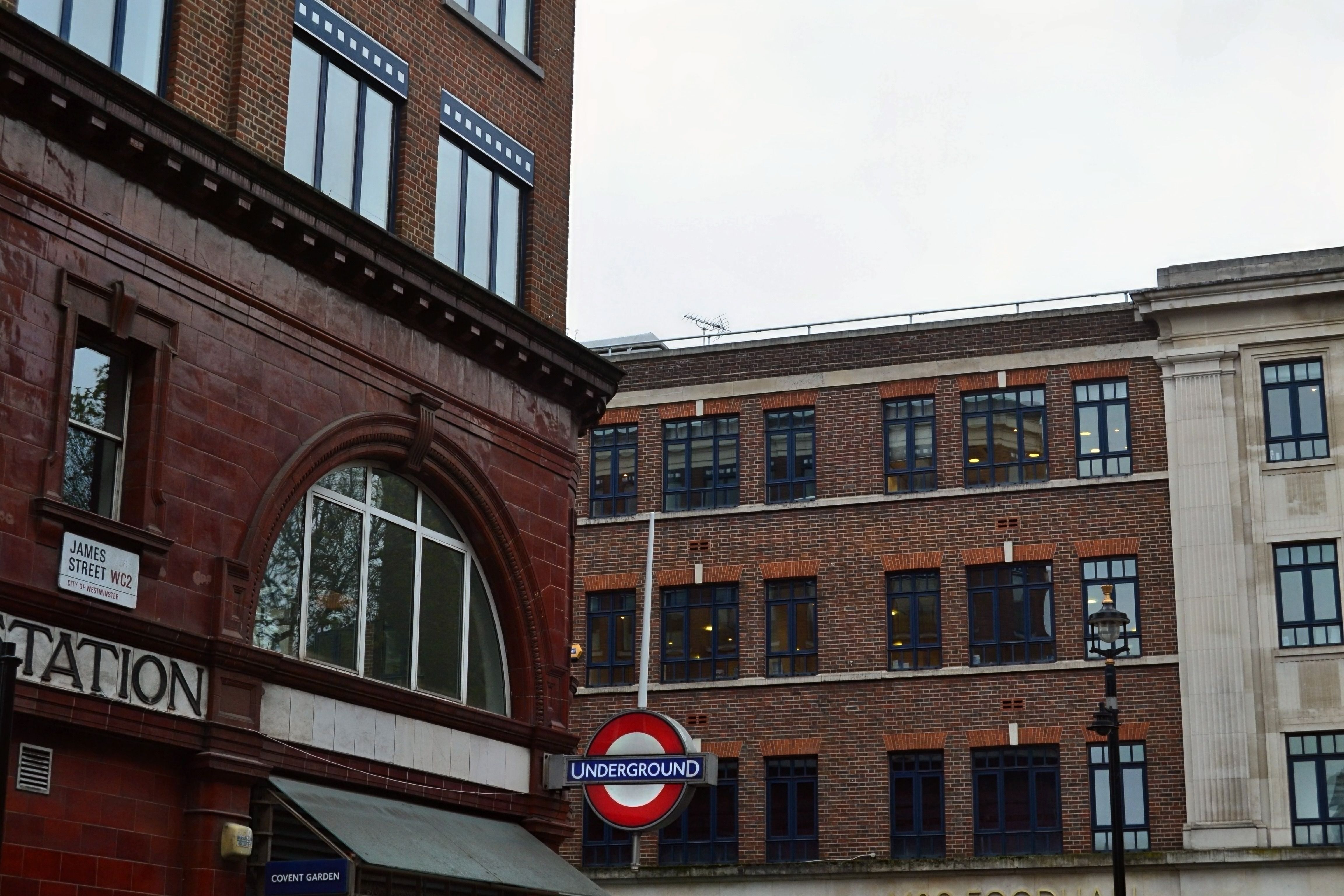 View of Covent Garden Station entrance with iconic Underground sign in London, England.