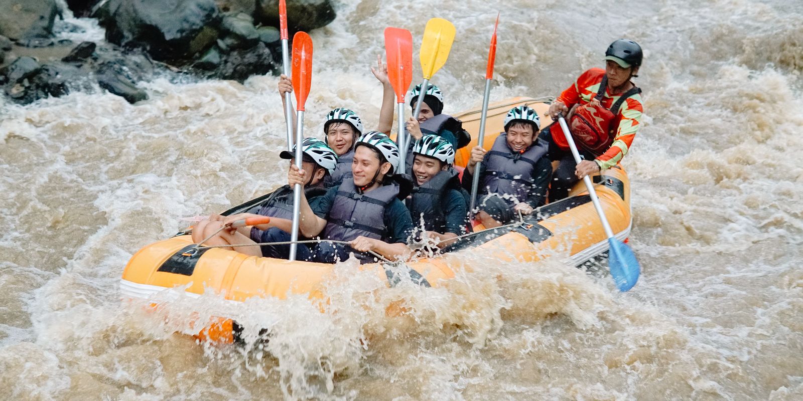 A rafting group navigating powerful whitewater rapids