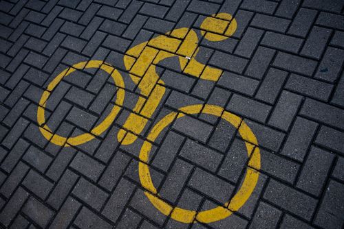 Free Yellow bicycle symbol painted on a paved street in Jakarta, Indonesia. Stock Photo