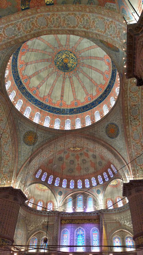Free Beautiful interior of an Ottoman-era mosque with intricate dome design and stained glass windows. Stock Photo