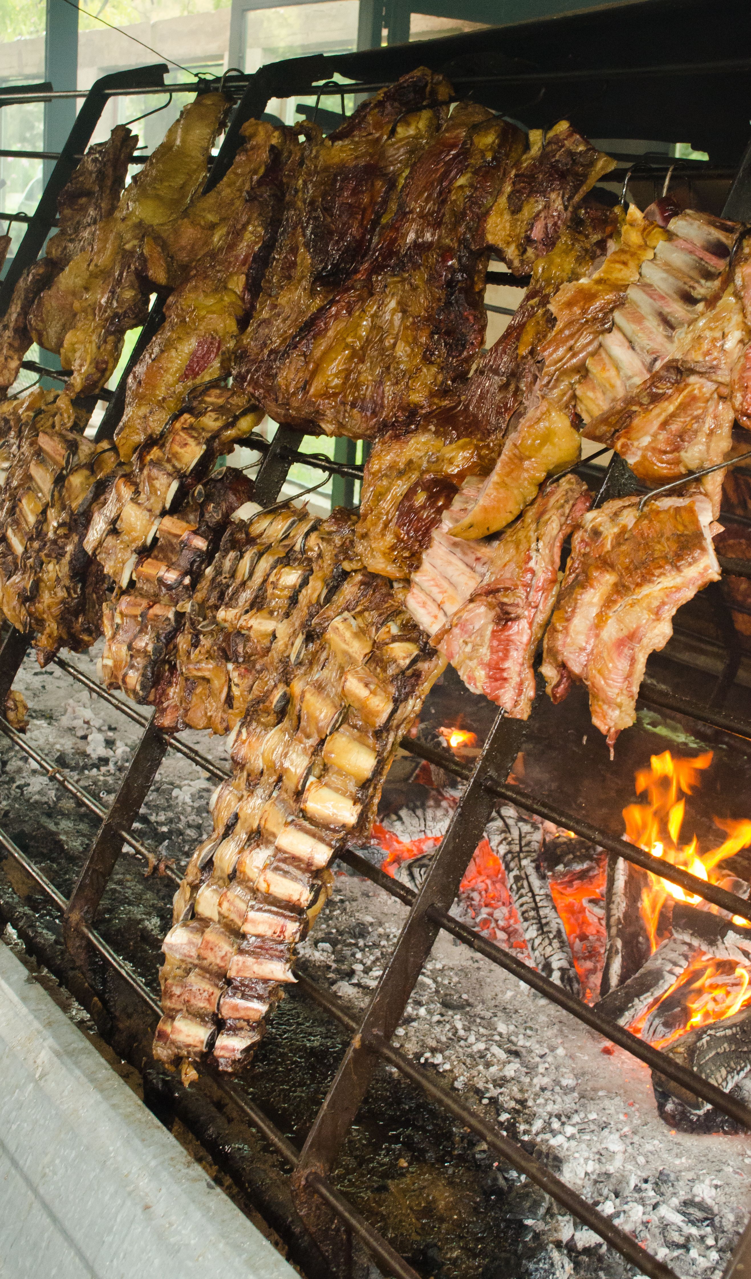 Authentic Argentine asado with ribs cooked over open fire.