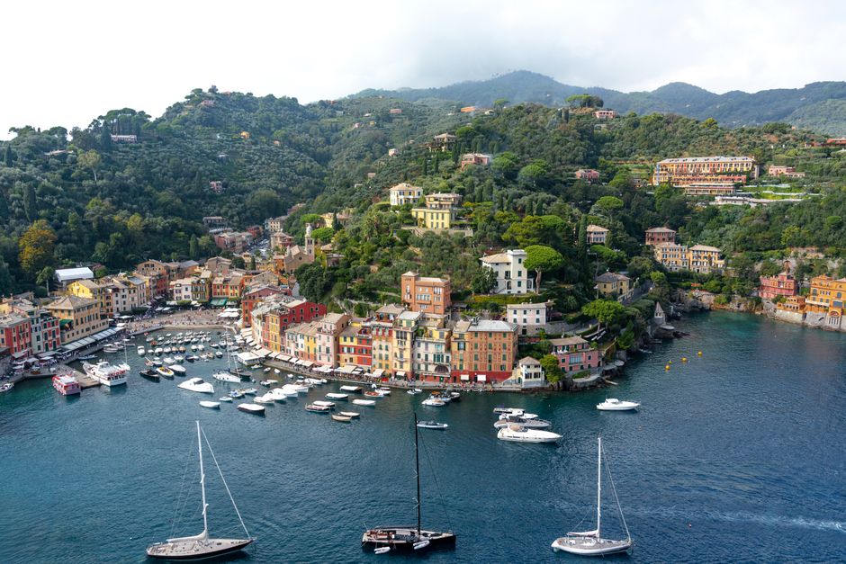 Incredible Gargano from Vieste Yacht Excursion with Aperitif and Skipper Review 2026 - A picturesque aerial view of Portofino's colorful harbor and lush hills with yachts docked by the waterfront.
