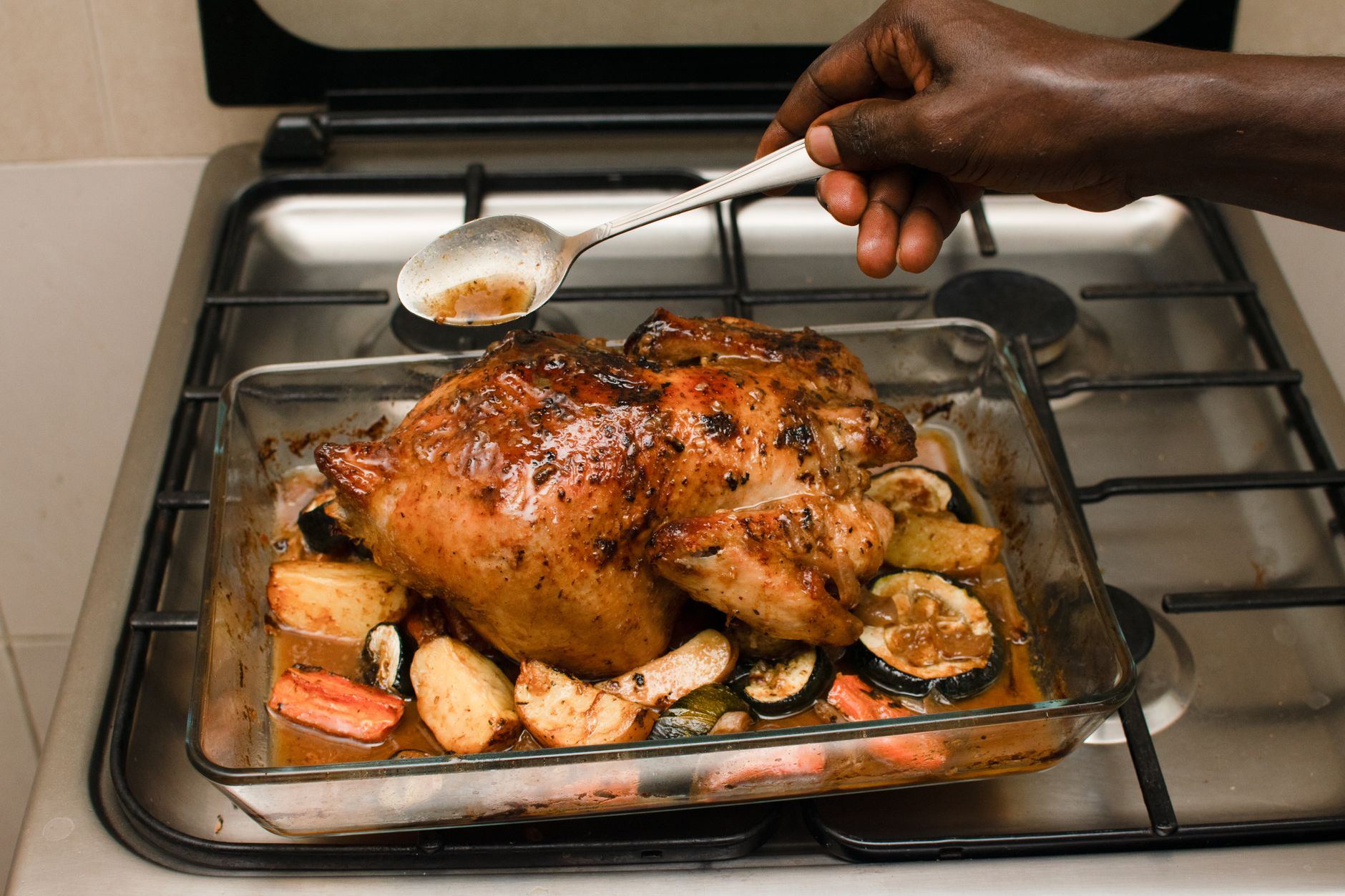 Golden roasted whole chicken in a cast iron Dutch oven