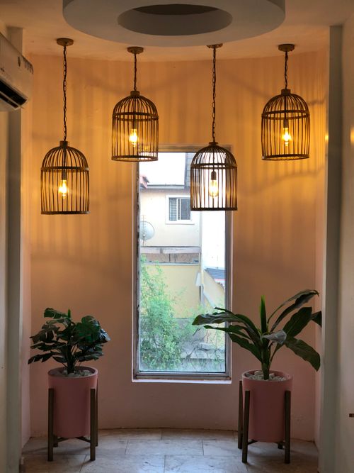 Free A cozy interior space featuring stylish hanging lights and potted plants in Lekki, Nigeria. Stock Photo