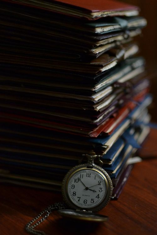 Free A stack of vintage books with a classic pocket watch. Perfect for themes of history, time, and literature. Stock Photo