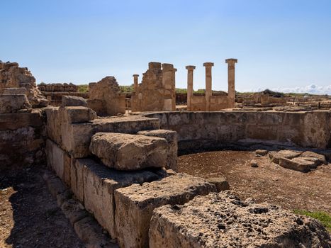 Explore the ancient ruins with limestone columns under a clear blue sky. Perfect example of historical architecture.