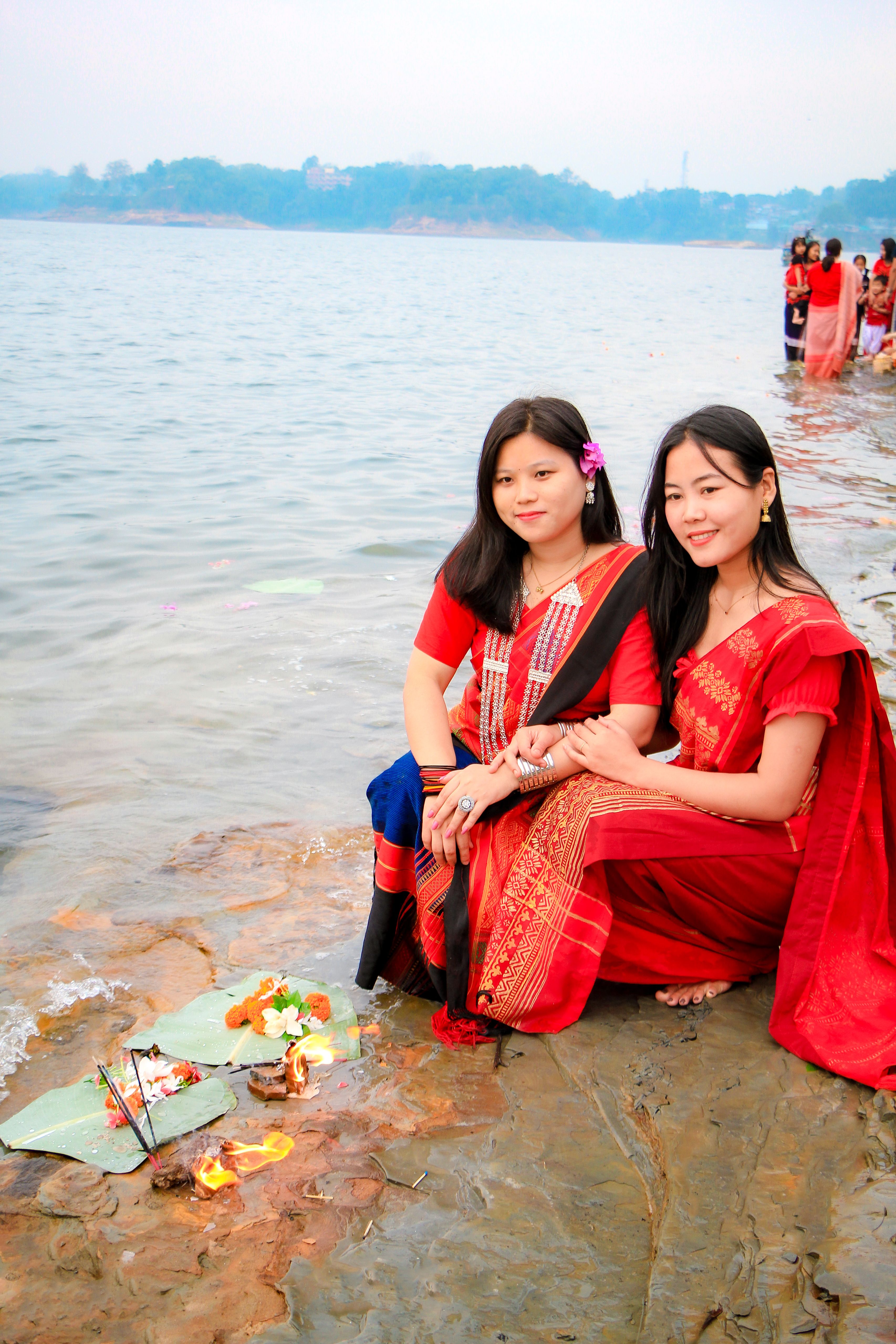 Women in traditional attire celebrate a New Year ritual by the river in Rangamati, Bangladesh.