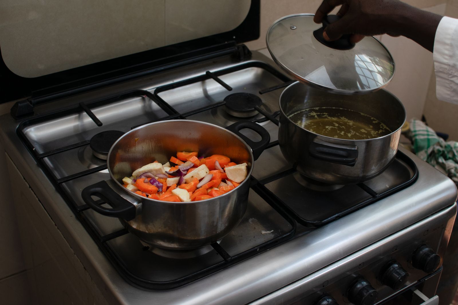Fresh vegetables and cookware being used for home cooking