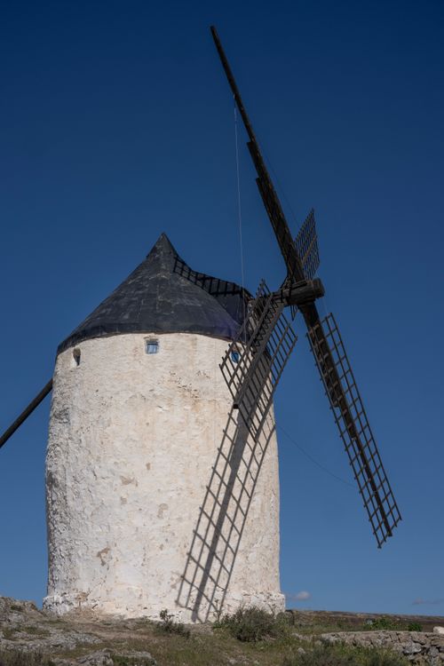 Free Traditional white windmill under a clear blue sky in Consuegra, Spain. Stock Photo