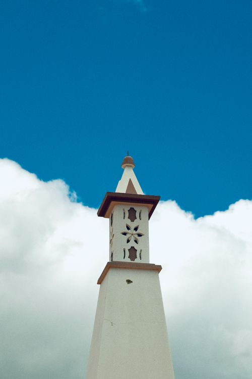 Free A historic Algarve chimney against a clear blue sky in Tavira, Portugal. Stock Photo