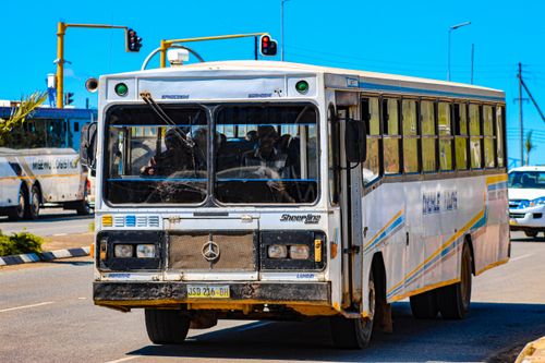 Free Busy city street scene with a local bus in Mankayane, Eswatini during the day. Stock Photo