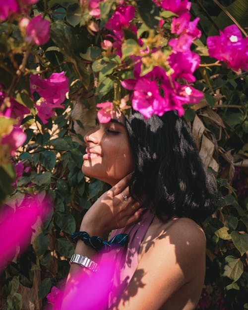 Photo of Woman Standing Near Pink Flowers