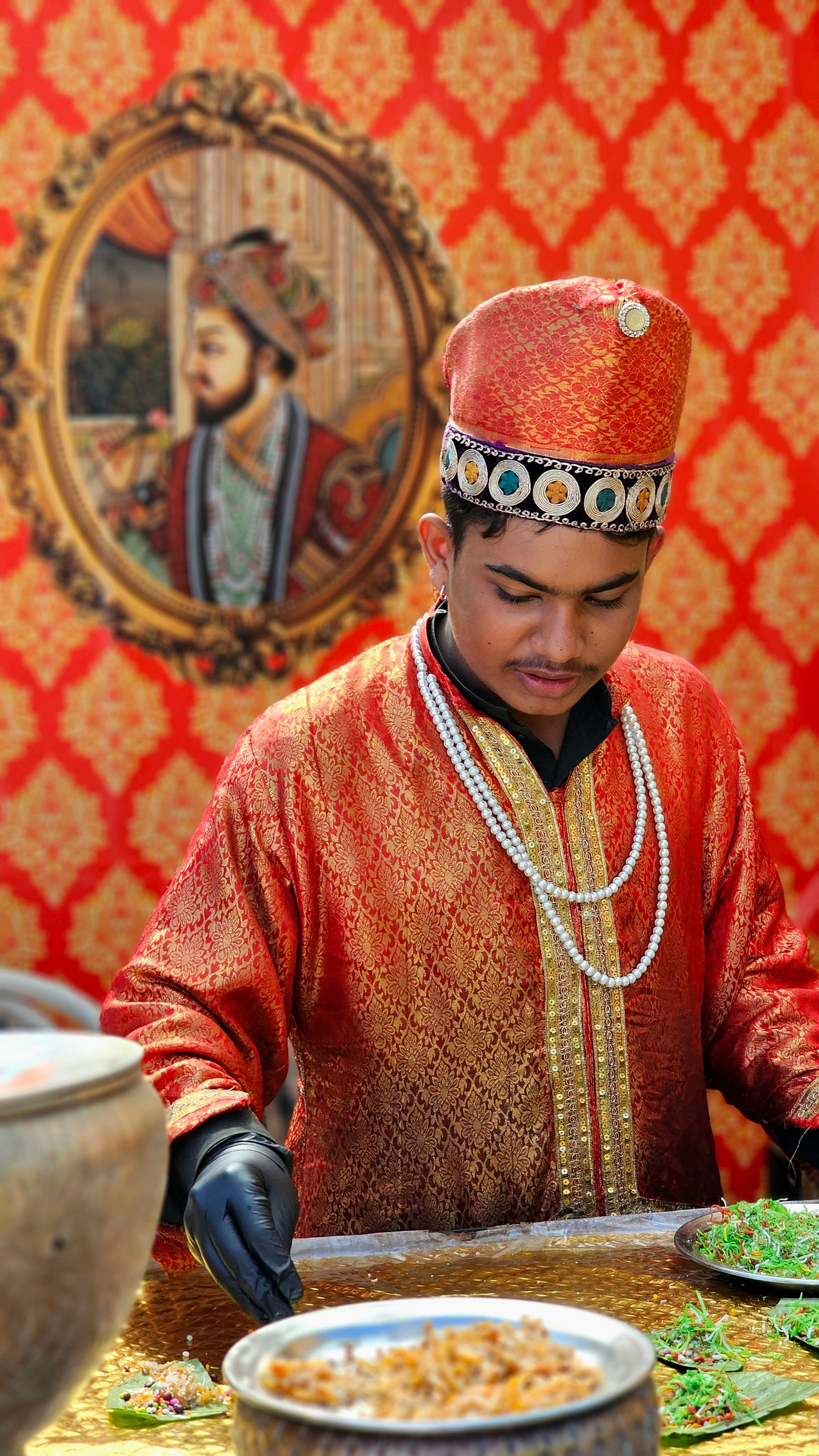 A Pakistani chef in traditional attire prepares a local dish, showcasing cultural heritage.