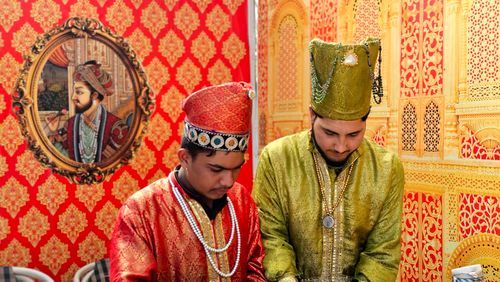 Free Men in traditional Mughal attire with ornate background, Islamabad, Pakistan. Stock Photo