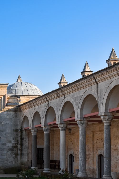 Free Stone arches and domed roof of historic building in Edirne, Türkiye under a clear blue sky. Stock Photo
