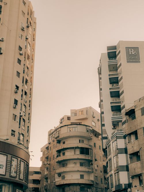 Free Cityscape view of high-rise buildings with a warm and muted tone capturing an urban environment. Stock Photo