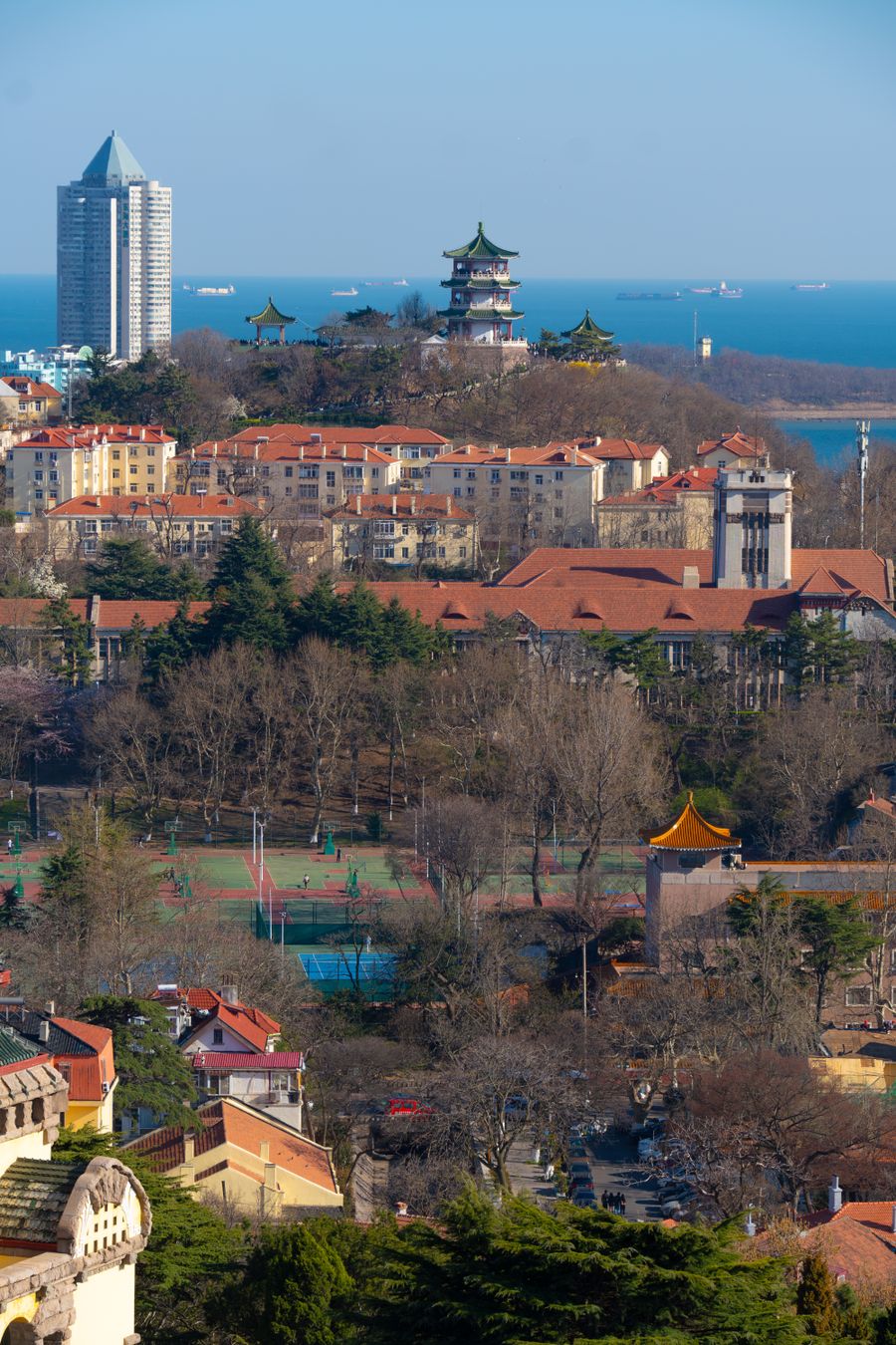 Aerial view of Qingdao's red rooftops and European villas stepping down to the bay