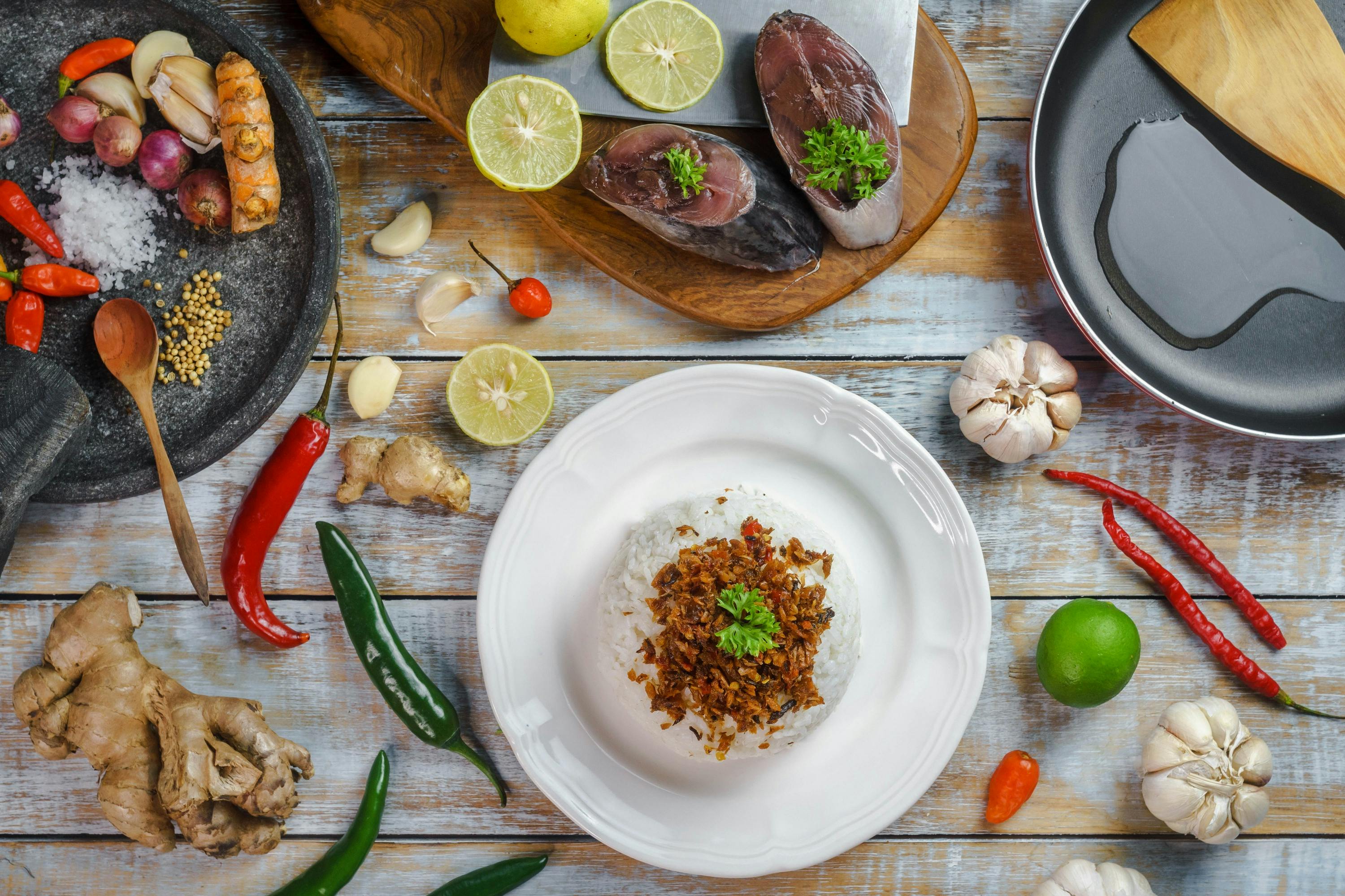 Flat lay of abon tuna with ingredients, showcasing Indonesian culinary culture on rustic background.