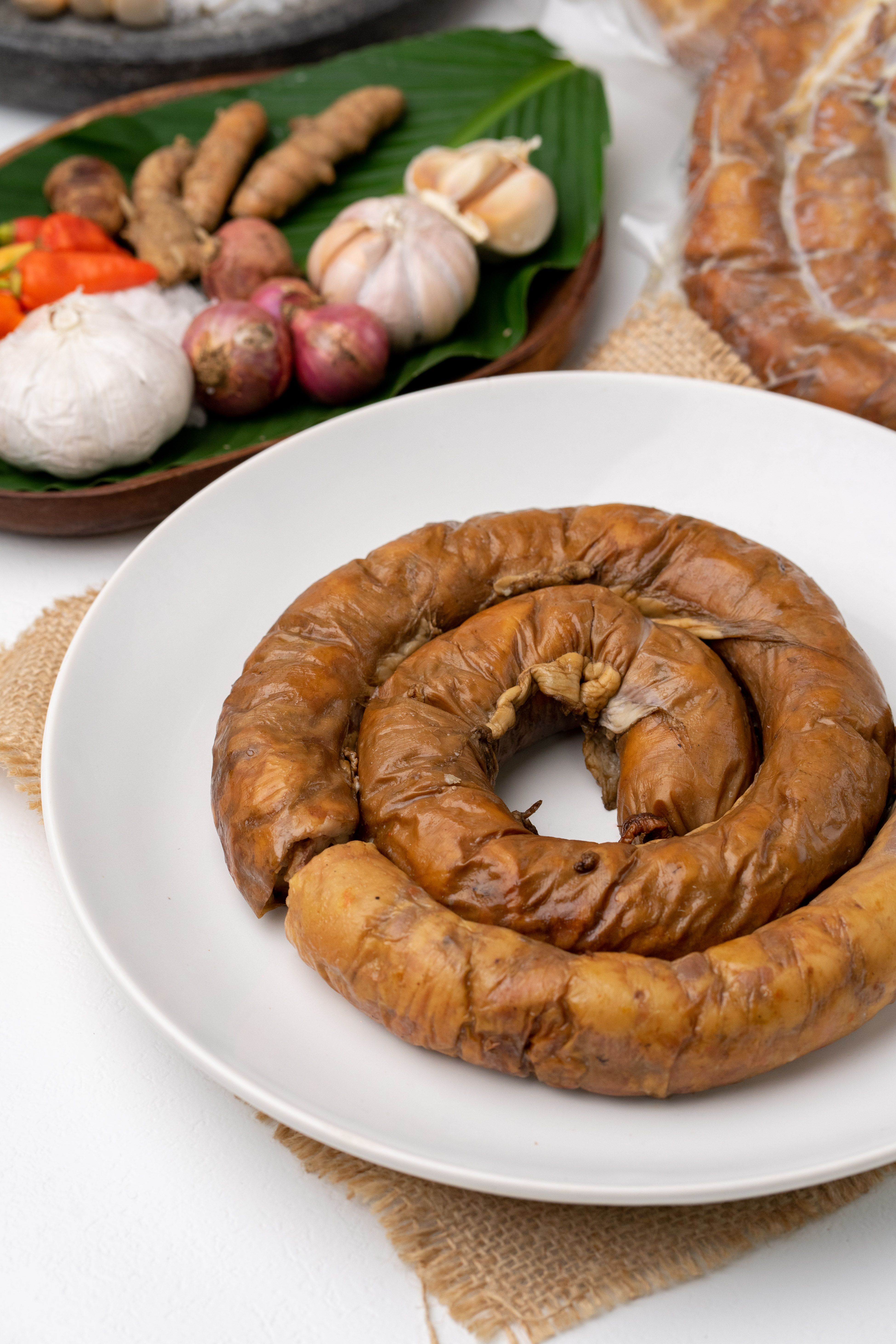Indonesian Balinese sausage 'Urutan' served on a plate with authentic spices, highlighting traditional flavors.