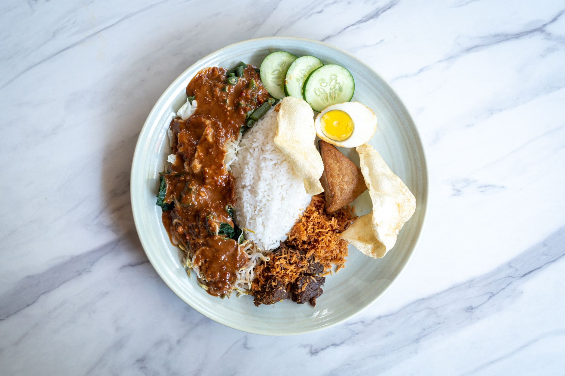 Top-view of Nasi Pecel, a traditional Indonesian dish with rice and vegetables from Bali.
