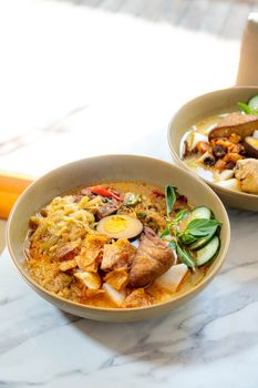 Delicious bowl of Sayur Lodeh with tofu and boiled egg highlights Indonesian flavors.